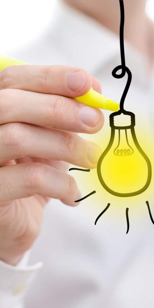 Idea light bulb word sketched on a white board Idea light bulb word sketched on a white board